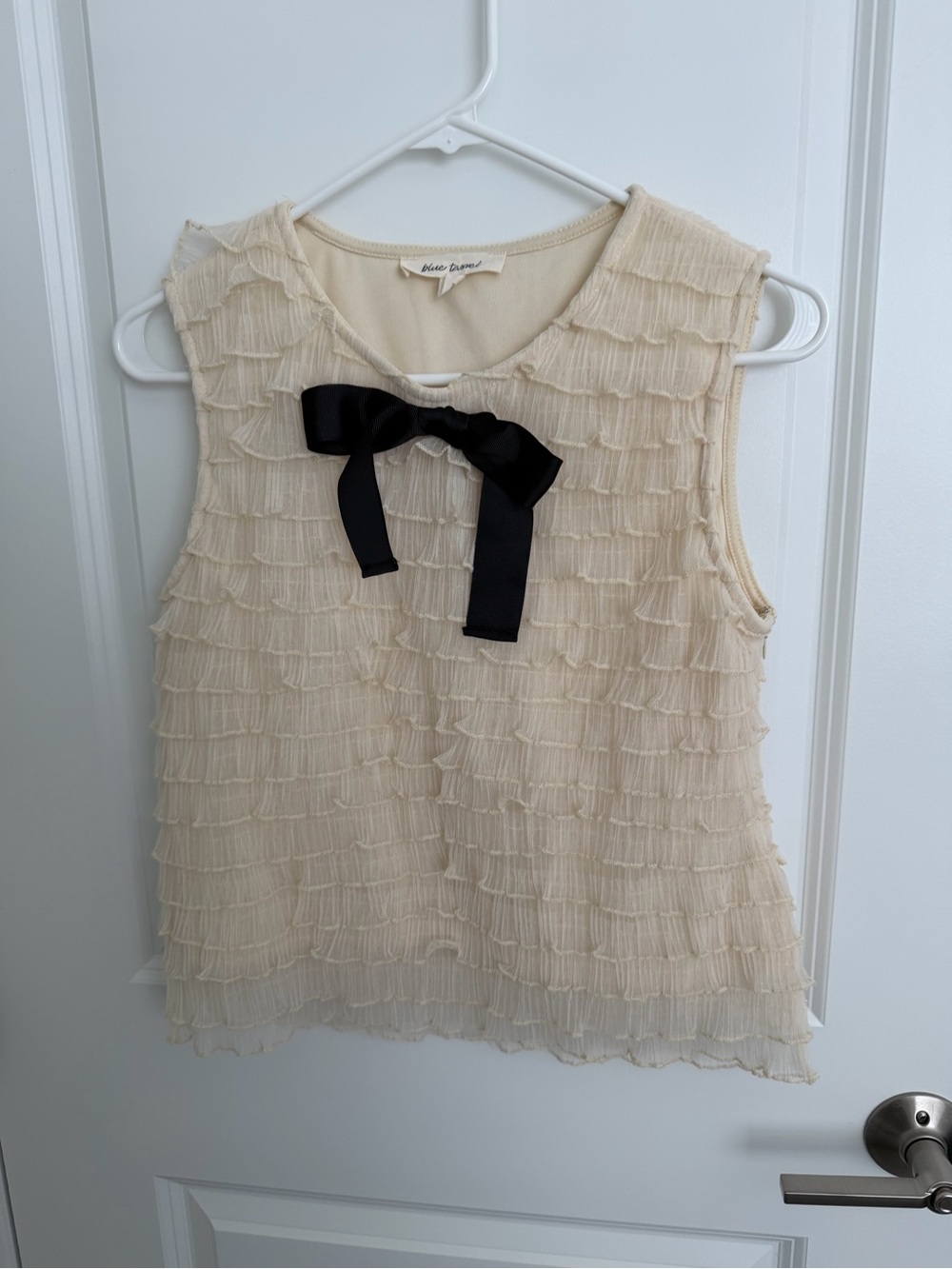 Sleeveless Cream Ruffle Shell with Black Bow